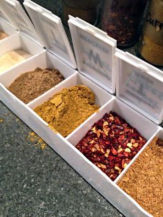 an assortment of spices in white containers