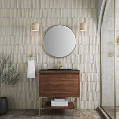 a bathroom with a sink, mirror and towel rack in front of a tiled wall