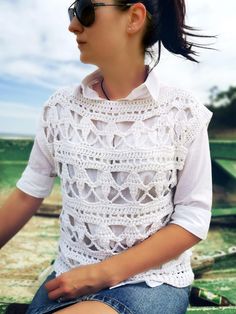 a woman wearing a white shirt and blue jeans