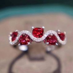 Exquisitely designed ring band features beautiful cushion shape vivid red spinels accented with petite round diamonds. The combination of these gemstones and gorgeous curving pattern of spinel and diamond makes this already unique ring a remarkable delicate piece. This Ring has gorgeous shine, superior quality and craftsmanship Details: 18K Solid white gold 1.30 ct Vivid Red Spinel 0.16 ct Genuine Diamonds Fabrication process usually takes 5-14 days, if you need it earlier, please let us know. Red Cushion Cut Ring With Accent Stones, Red Cushion Cut Gemstone Ring, Luxury Radiant Cut Red Ring, Cushion Cut Ruby Gemstone Rings, Ruby Rings With Accent Stones In Cushion Cut, Ruby Rings With Cushion Cut And Accent Stones, Red Spinel Ring, Butterfly Diamond Ring, Spinel Engagement Ring