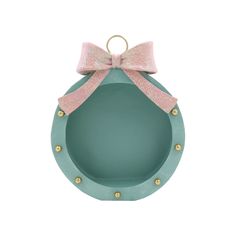 an ornament with a pink bow on the top and gold studding around it