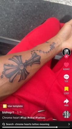 a person with a cross tattoo on their arm