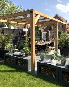 an outdoor patio with potted plants and wooden pergols on the side of it