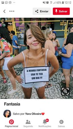 a woman holding a sign that says fantasia in spanish on the front of her shirt