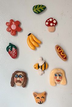 there are many different magnets on the refrigerator door that look like they're eating food