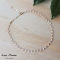 A Simple & Delicate Moonstone Choker for those who love a little boho in their style  > Natural tiny faceted moonstone gemstones (trust us the pics do not do these justice)! created in a rosary style. > 14k gold fill chain & findings. > Choker/Necklace measures approx. 31cm (12.2 inches) with extender chain measuring 7cm (2.75 inches). > Handmade with love. > Arrives to you in a beautiful gift box with care instructions. > Also available in Sterling Silver: https://www.etsy.com/au/listing/627359 Delicate Gemstone Beaded Necklaces, Dainty Moonstone Jewelry With Gemstone Beads, Dainty White Faceted Necklace, Dainty Beaded Moonstone Jewelry, Gold Jewelry With Gemstone Beads For Summer, Bohemian Moonstone Jewelry With Faceted Beads, Bohemian Faceted Moonstone Jewelry, Bohemian Moonstone Necklace With Faceted Beads, White Dainty Crystal Necklace With Natural Stones