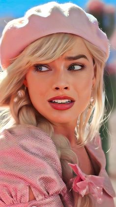 a close up of a person wearing a pink hat and dress with long blonde hair