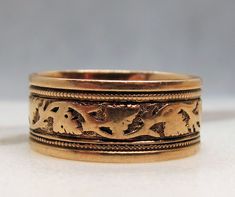 "Offering a beautiful 14k  Rose Gold Victorian eternity band.   It has an engraved pattern with vines etched going all the way around the band.   It measures 7.55mm wide so it makes a nice presentation.  I love the rose gold with engraving adding dimension to the band. The band is marked \"14\".   It is a size 6.25 however due to the band being wide, it fits more like a 6.     The band weighs 3.1 grams.   I love these old wide Victorian engraved bands.   This would work for either a man or woman.   I have been selling jewelry for two decades. I am not a gemologist and not qualified to grade diamonds. I do occasionally give an estimate to the best of my ability to give you some idea of the quality of the diamond to aid in your decision, as well as the pictures. My items are vintage items an Vintage Engraved Wedding Rings, Antique Wedding Bands, Diamond Sapphire Engagement Ring, Sapphire Diamond Engagement, Engraved Wedding Rings, Antique Roses, Diamond Rings Bands, Eternity Band, Men's Rings