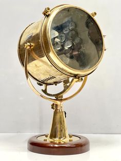 an antique brass desk lamp on a wooden base