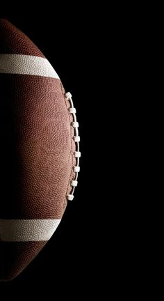 an american football on a black background with room for your own text or image to be added