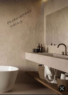 a white bath tub sitting on top of a bathroom floor next to a sink and mirror