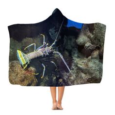 a woman standing under a hooded blanket with a lobster on it