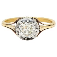 an old - fashioned diamond ring with two tone gold and white diamonds in the center