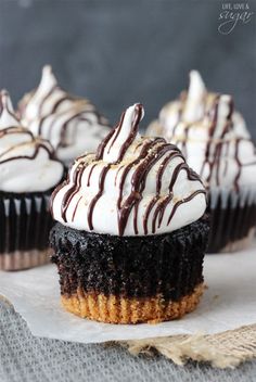 chocolate cupcakes with white frosting and drizzled on the top