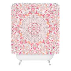 a pink and white shower curtain with an intricate design