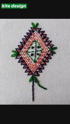 a close up of a piece of cloth with embroidery on it and a flower in the middle