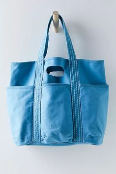 a blue tote bag hanging on the wall