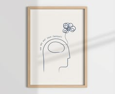 a framed poster with a drawing of a person's head and flowers