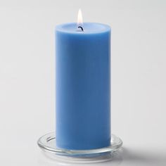 a blue candle sitting on top of a glass holder