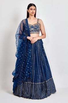 Blue lehenga with all over zari work in striped pattern. Paired with a cutwork embroidered padded blouse in zari, dabka and nakshi and an embroidered dupatta.
Components: 3
Pattern: Embroidered
Type Of Work: Zari, Dabka, Nakshi
Neckline: Sweetheart
Sleeve Type: Sleeveless
Fabric: Georgette
Color: Blue
Other Details: 
Embroidered dupatta
Length
Blouse: 14.5 inches
Lehenga: 45 inches
Approx. product weight: 4 kgs
Closure:
Lehenga: Zipper
Model Height: 5 ft 9 inches, wearing size M
Occasion: Weddin Cutwork Blouse, Blue Lehenga, Padded Blouse, Embroidered Lehenga, Embroidered Dupatta, Zari Work, Cut Work, Set For Women, Aza Fashion