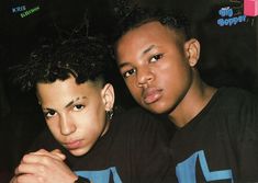 two young men are posing for the camera with their arms around each other's shoulders