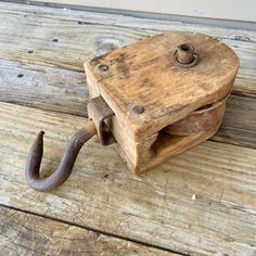 an old wooden box with a hook on it