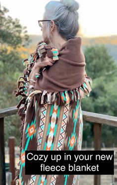 an older woman with glasses and a scarf over her head is standing on a wooden deck