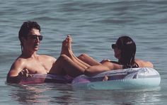 the man and woman are sitting on an inflatable raft