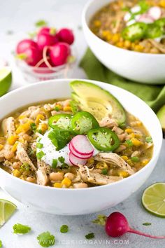 two white bowls filled with chicken, corn and avocado soup next to sliced radishes