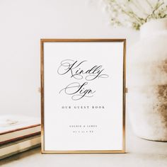 a book sitting on top of a table next to a vase with flowers in it