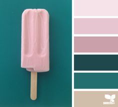 a popsicle on a stick with different shades of pink and blue in the background