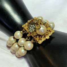 Gorgeous DE MARIO Vintage Signed Bracelet. Made in the 1940s-1950s with Faux Pearls, Gold Plated Metal, Crystal  Rhinestones and a gorgeous Floral Metal Filigree Beadwork design for the focal point of the bracelet complimented by the pearls. The intertwined seed pearls with leaves is just stunning. The craftsmanship does not go unnoticed in his pieces.  Measures - 8" inches "Robert De Mario (Est. 1945 - 1965) Sources disagree about whether Robert De Mario began his jewelry design career in the 1940s working for assorted New York City designers or specifically with Miriam Haskell. This could be because De Mario's work is occasionally confused Haskell's as there is a similarity in the intricacy of both designers' beadwork and pearl designs. There is, however, no disagreement that De Mario op Elegant Wedding Bracelets With Vintage Charm, Vintage Gold Beaded Bracelets, Vintage Gold Pearl Bracelet With Round Beads, Gold Vintage Pearl Beaded Bracelet, Victorian Jeweled Wedding Bracelets, Vintage Pearl Bracelet With Round Beads For Formal Occasions, Vintage Beaded Bracelets For Party, Vintage Beaded Bracelets For Wedding, Antique Beaded Wedding Jewelry