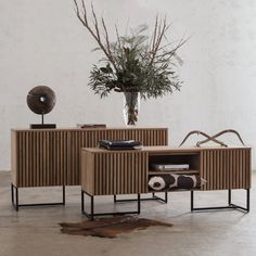 two side tables with plants in the middle and a planter on top, sitting next to each other