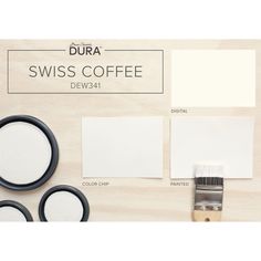 some white paint and other items on a wooden surface with the words swiss coffee below it