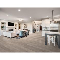 a living room filled with furniture and a fire place next to a kitchen counter top