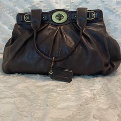 This Gathered Rich Brown Leather Purse Is A One Of A Kind! It Features Brass Hardware (With Minimal Wear), Turn Lock Closure (With Signs Of Wear) And Magnetic Closures For Added Protection. The Bag Has A Gorgeous Light Purple Lining (Definitely Shows Signs Of Wear With Some Makeup And Pen Marks) And 6 Different Sized Pockets The Middle One Has A Zipper. The Leather Could Use A Polish To Shine It Up But The Bag Still Has Years Of Like Left In It! Medium Purse, Some Makeup, Brown Leather Purse, Brown Leather Shoulder Bag, To Shine, Medium Bags, Leather Purse, Brass Hardware, Light Purple