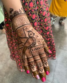 a woman's hand with henna tattoos on it