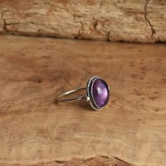 This is a perfect dainty amethyst ring - .925 Sterling Silver - Amethyst - Lavender Amethyst Sometimes you want to gaze down at your ring and see perfect balance and grace. That's what the Delica Dainty Ring has to offer. High- grade Amethyst with a simple, sterling silver design. Perfect little ring. Lovely, traditional, dainty ring of 10 x 12mm Amethyst cabochon set in .925 sterling silver oxidized and burnished bezel and wire. Simple, elegant and perfect. This lovely little ring is created us Silversmith Rings, Chloe Ring, Lavender Amethyst, Purple Amethyst Ring, Purple Rings, Amethyst Gem, Silver Design, Purple Band, Jade Ring