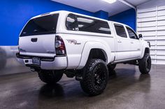 a white truck is parked in a garage