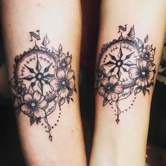 two tattoos on both legs with flowers and compass