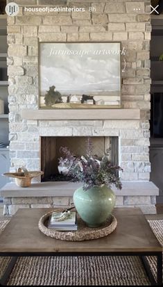 a living room filled with furniture and a fire place in front of a stone fireplace