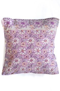 a purple and white pillow with flowers on it