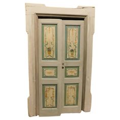 an old white door with green and yellow designs on it's sides, isolated against a white background