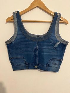 Stylish and versatile, this vintage-inspired denim crop top features a classic blue wash with subtle fading for a worn-in look. Designed with unique stitching details, functional button accents, and faux pocket embellishments, this piece adds a trendy, casual vibe to your wardrobe. Perfect for layering or pairing with high-waisted jeans or skirts, it combines comfort and style effortlessly. Navy Crop Top, Denim Crop Top, Jean Vintage, Stitching Details, Cropped Tops, Classic Blue, Pocket Detail, Vintage Jeans