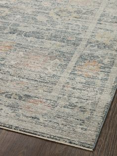 an area rug with wood flooring on top of it and a wooden floor in the background