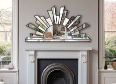 a living room with a fire place and mirror on the wall above it's mantle