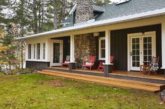 a house with red chairs on the front porch