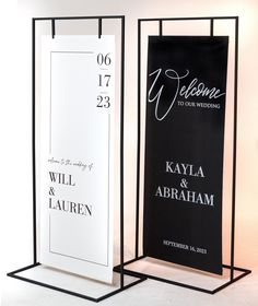 two black and white wedding signs on display