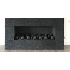 a black fireplace with balls in it