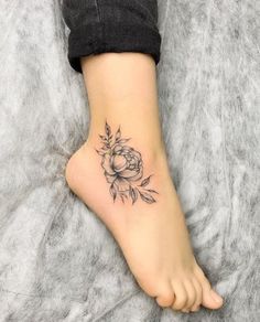 a person with a flower tattoo on their foot